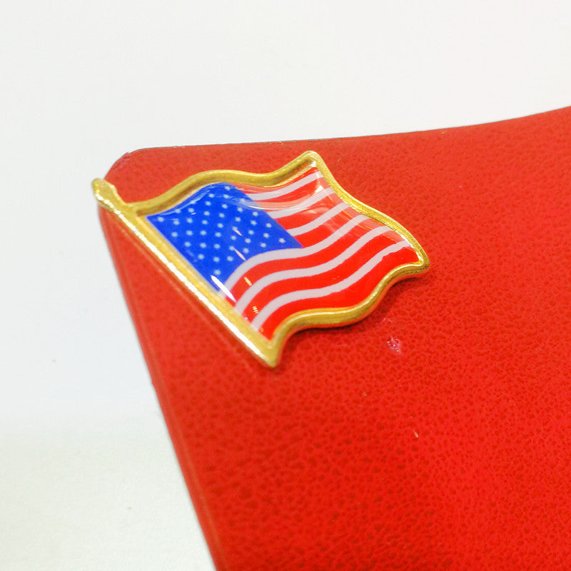 American Flag epoxy brooch badge on red background.